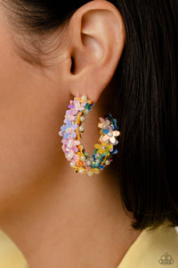 A floral explosion, encompassing the entirety of a thick silver hoop, features reflective light blue, pink, and yellow flowers dotted with dainty pearl centers for a dreamy, whimsicality below the ear. Earring attaches to a standard post fitting. Hoop measures approximately 1 1/2" in diameter.  Sold as one pair of hoop earrings.